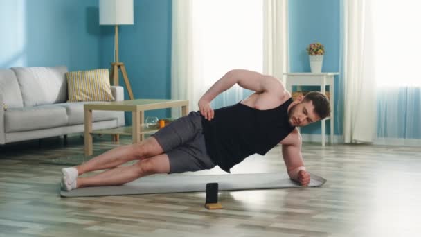 Athletic Man Is Standing In Side Elbow Plank - Metraje, vídeo