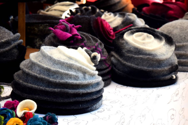 Many different hats made of felt on a market stand - Photo, Image
