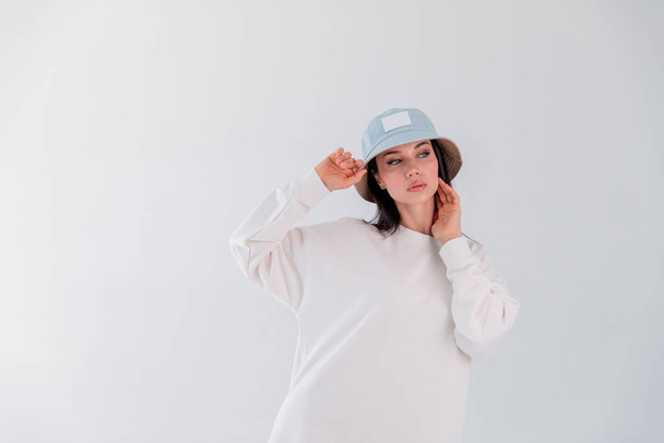 Portrait beautiful adult sports girl model on white background. hoody. logo. Copy space - 写真・画像