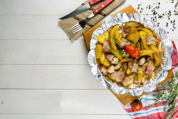 baked potatoes with bacon on a wooden background - Φωτογραφία, εικόνα