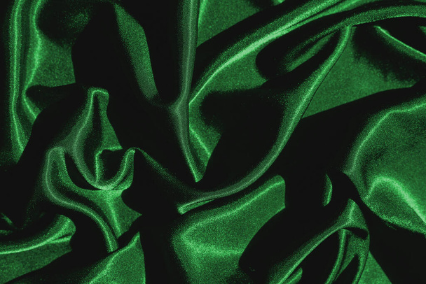 Smooth elegant green silk or satin luxury cloth texture can use as abstract background. Luxurious background design - Foto, Imagen