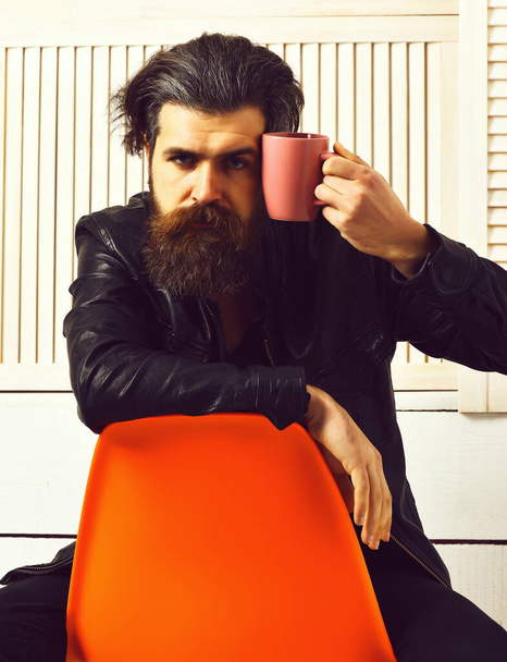 Brutal caucasian hipster holding cup or mug - Fotó, kép