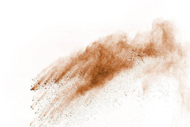 Brown color powder explosion on white background. Colored cloud. Colorful dust explode. Paint Holi. - Photo, image