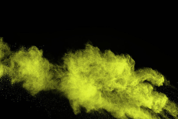 The movement of abstract dust explosion frozen green on black background. Stop the movement of powdered green on black background. Explosive powder green on black background. - Foto, Bild