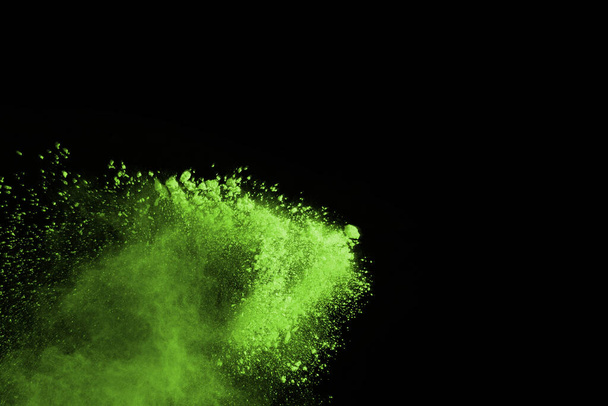 The movement of abstract dust explosion frozen green on black background. Stop the movement of powdered green on black background. Explosive powder green on black background. - Fotoğraf, Görsel