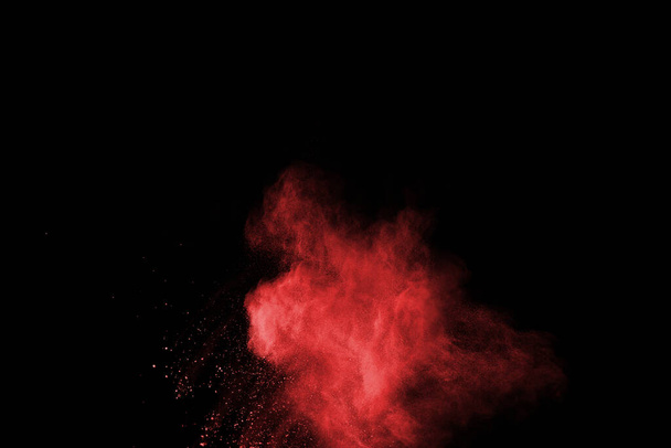 abstract red powder explosion on black background.abstract red powder splatted on black background. Freeze motion of red powder exploding. - Фото, зображення