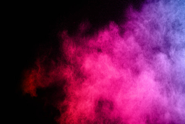 abstract colored dust explosion on a black background.abstract powder splatted background,Freeze motion of color powder exploding/throwing color powder, multicolored glitter texture. - Foto, Bild