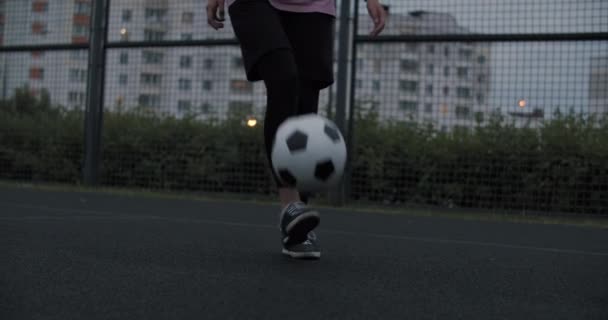 Girl practicing soccer skills and tricks - Filmati, video