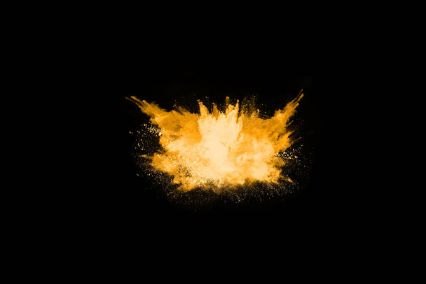 Freeze motion of yellow dust explosion isolated on black background. - Photo, Image