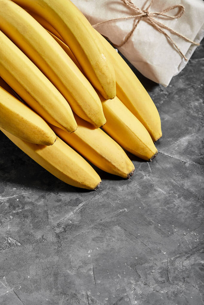 Bananas isolated on gray cement background Clipping Path - Photo, Image