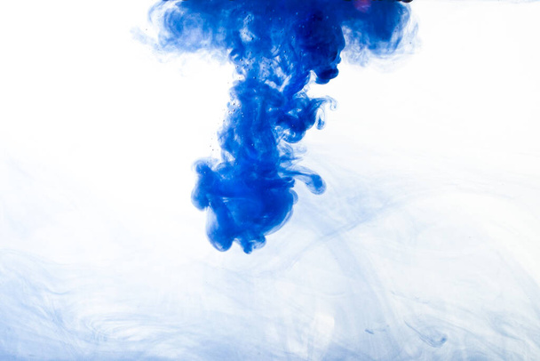 A cloud of blue paint released into clear water. Isolate on a white background. - Foto, Imagen