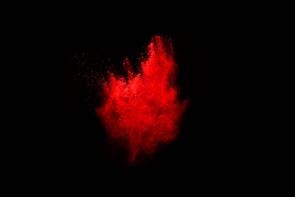 abstract red powder explosion on black background.abstract red powder splatted on black background. Freeze motion of red powder exploding. - Fotografie, Obrázek
