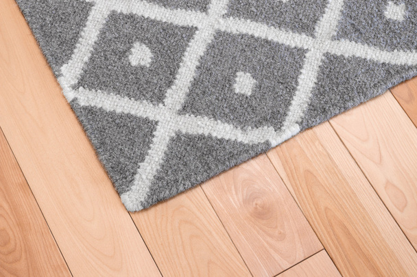 šedý koberec na dřevěnou podlahu - Fotografie, Obrázek