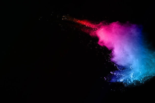 abstract colored dust explosion on a black background.abstract powder splatted background,Freeze motion of color powder exploding/throwing color powder, multicolored glitter texture. - Foto, imagen