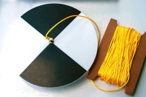 Secchi disk with rope on a white table, prepared for water transparency measurement. - Foto, immagini