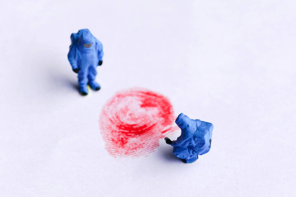The concept of miniature crime scene investigator with red fingerprint                                 - Φωτογραφία, εικόνα