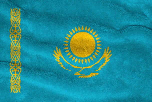 Towel fabric pattern flag of Kazakhstan, Crease of Kazakhstani flag background. A gold sun above eagle on blue field and national ornamental pattern. - Photo, Image