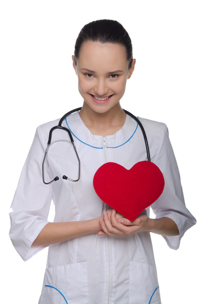 Doctor supporting red heart - Foto, afbeelding