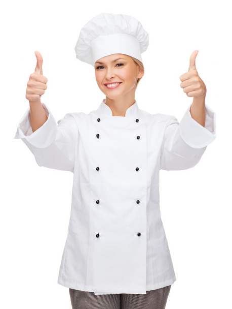 Smiling female chef showing thumbs up - Fotó, kép