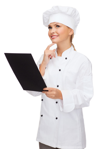 Smiling female chef with black blank paper - Foto, Bild