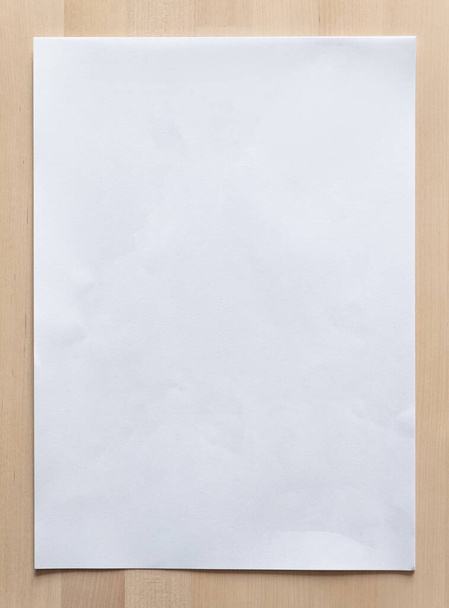 White paper sheet on wood for business background. Close up image. - Fotó, kép