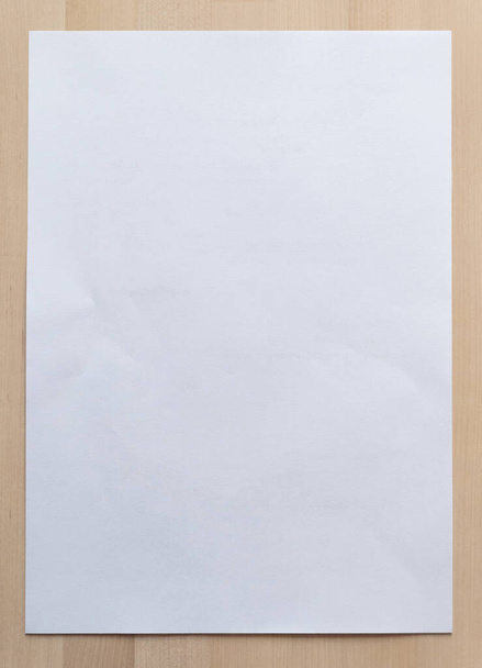 White paper sheet on wood for business background. Close up image. - Foto, Imagem