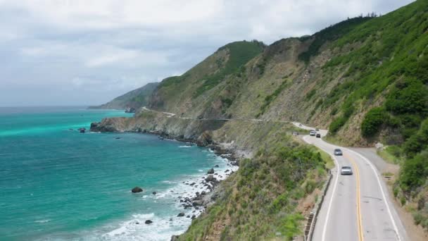 Yeşil dağlar ve açık mavi okyanusla Pasifik kıyı şeridinde hava manzarası - Video, Çekim