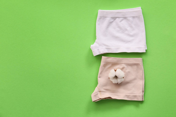 Cotton female underwear on color background - Foto, afbeelding