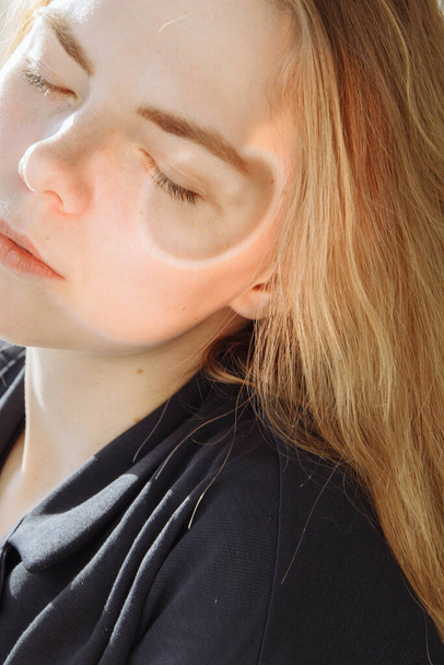 Close-up portrait of a beautiful redhead girl with closed eyes.  - Фото, изображение