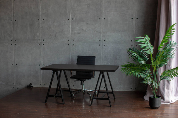 desk in the office. Tropical flower in a pot. Office or home interior. - Photo, Image
