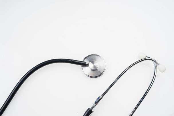 Medical or healthcare concept. Stethoscope isolated on white background. Flat lay or top view. - 写真・画像