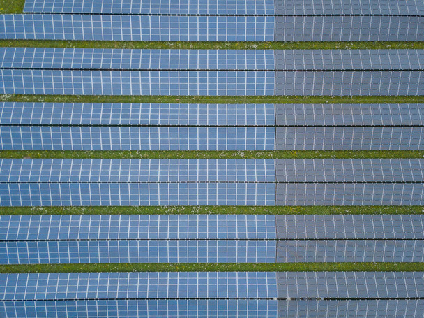Aerial view of solar panels for photovoltaic power generation on field. - Photo, Image