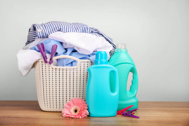 Detergent with washing powder and towels over white wall - Photo, Image