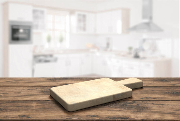 drewniany blat stołowy z deską do krojenia przed zamazaną kuchnią - Ilustracja 3D - Zdjęcie, obraz