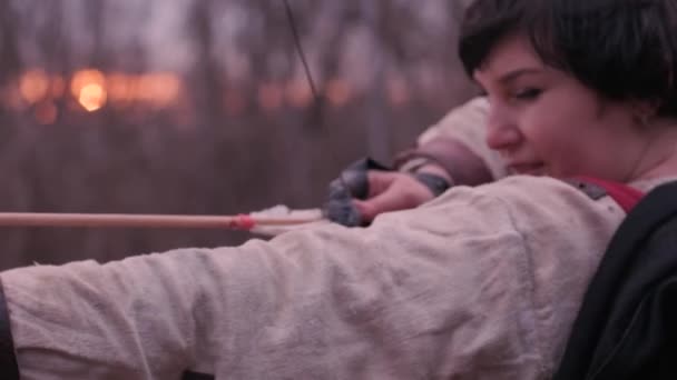 Warrior woman shoots a bow in the target - Footage, Video