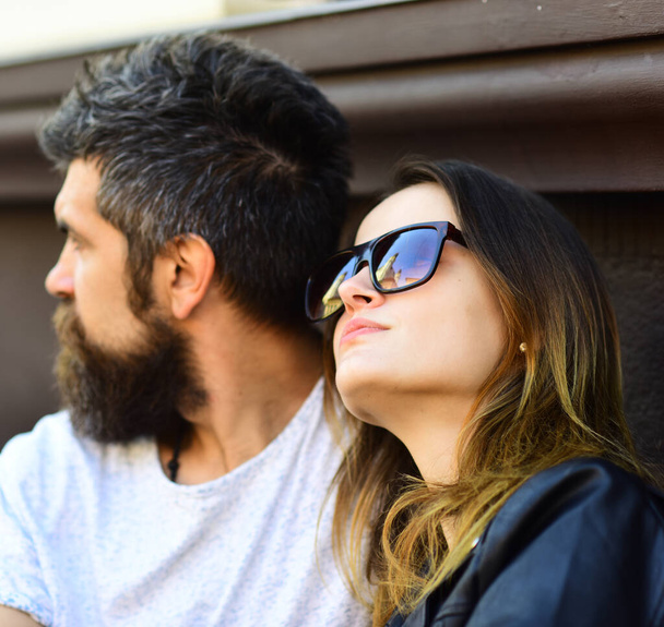 Girl and bearded guy look at each other on terrace - 写真・画像