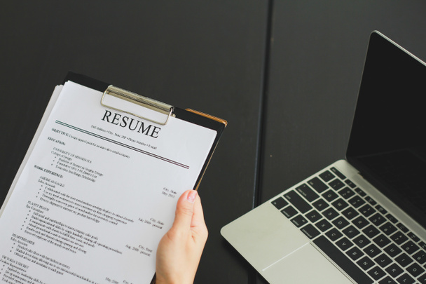 Close-up photo of a businesswoman holding resume - Photo, Image