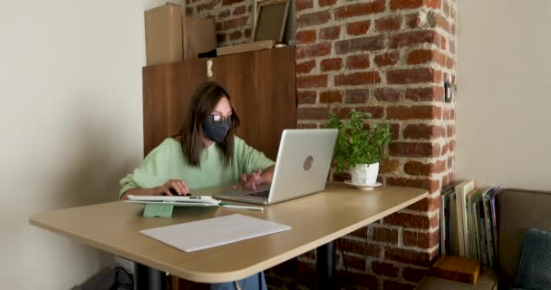 Woman in mask working at night using laptop - Footage, Video