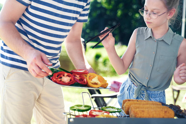 Father and daughter having barbecue grill for lunch  - Photo, Image
