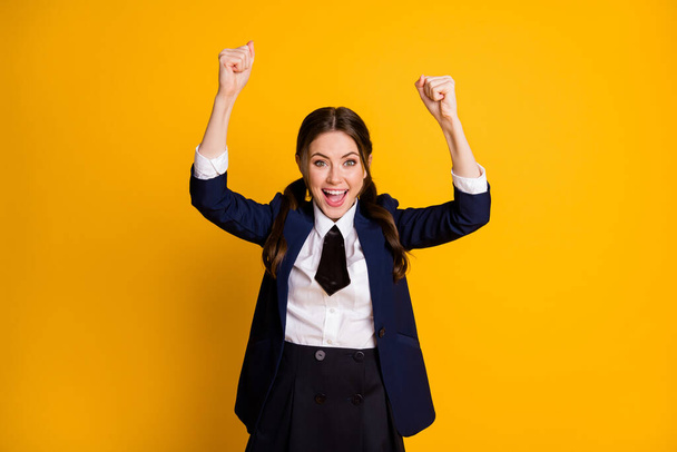 Portrait of her she nice attractive pretty ecstatic overjoyed lucky cheerful cheery schoolgirl celebrating triumph rising hands up isolated on bright vivid shine vibrant yellow color background - Foto, Imagen