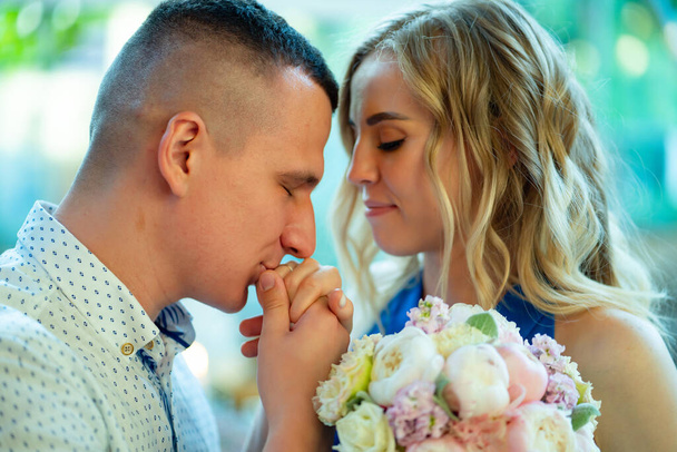 groom kisses bride's hand with wedding ring.  - Fotografie, Obrázek