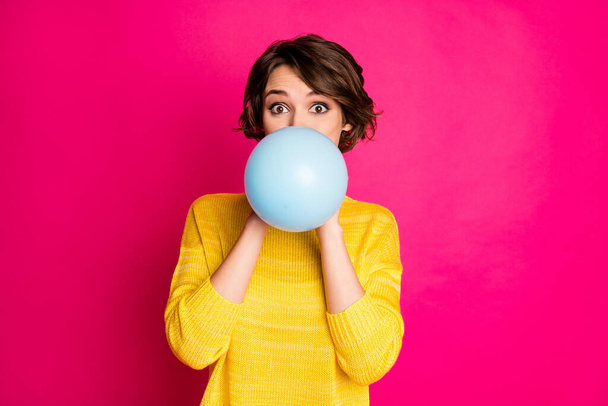 Portrait of cute funny lovely youth girl have festive occasion prepare party blow inflate balloon wear vivid jumper isolated over shine color background - Foto, afbeelding