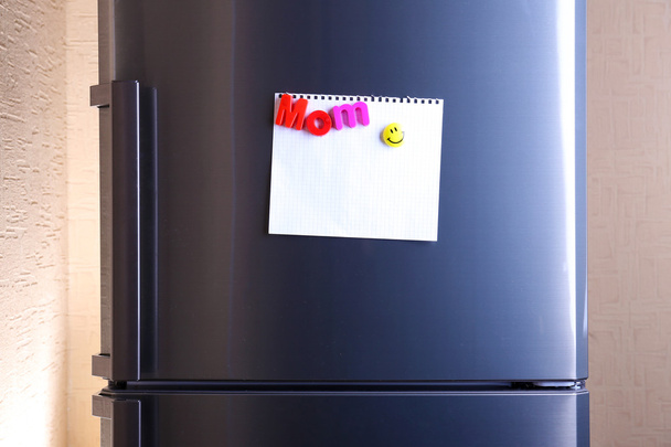 Empty paper sheet on fridge door - Фото, изображение