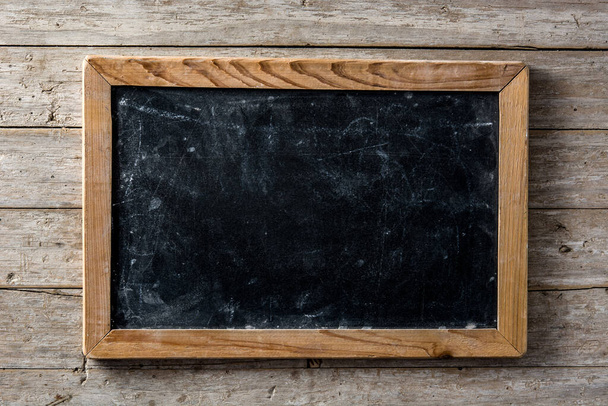 Blackboard on wooden background with copy space - Photo, Image