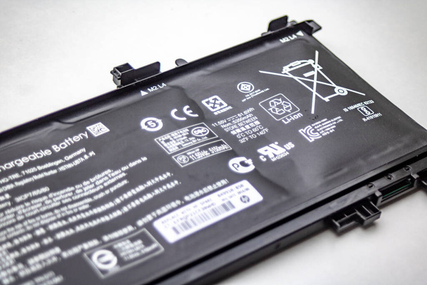 Heidelberg, Germany - August 02, 2019: Replacement of a defect, bloated HP Notebook Lithium-ion battery - Photo, Image
