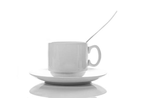 empty small white porcelain coffee Cup with a spoon on a white saucer side view isolated on a white background - Fotoğraf, Görsel