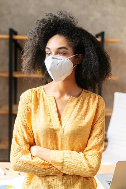 An african-american young woman in medical mask - Foto, Imagen