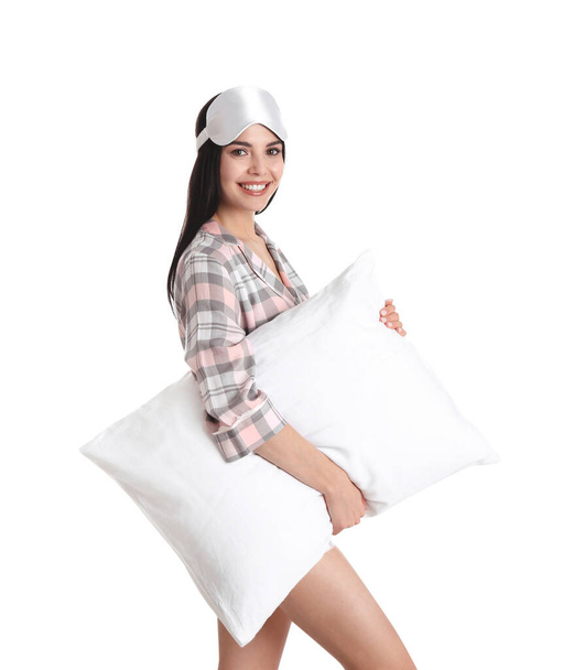 Young woman with pillow and sleep mask on white background - Valokuva, kuva