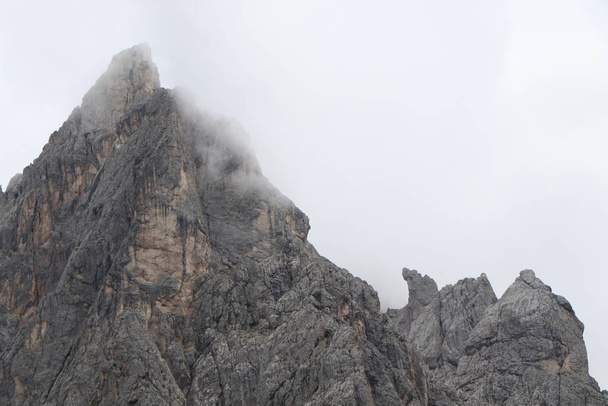 A close up of a rock mountain with clouds - Foto, immagini