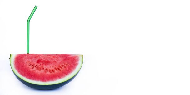 Fresh red watermelon and glass green eco reusable straw isolated on white background. fresh fruits and natural juices. Space for text.Fresh Watermelon Juice for summertime - Fotó, kép